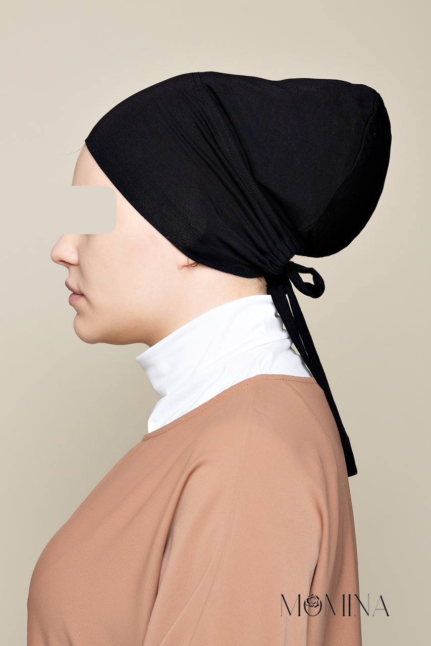 Model wearing a Black colored Satin Lined Undercap in a tie-back design made with Bamboo jersey - Side pose - Momina Hijabs