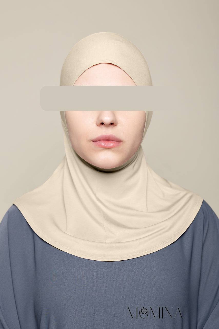 A woman wearing a light warm gray bamboo jersey ninja tie-back undercap by Momina Hijabs