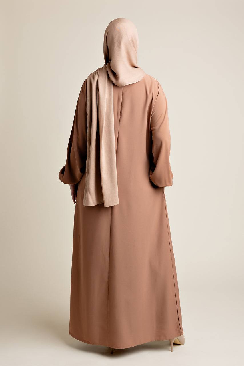 Model wearing a classic Abaya with side pockets in a tan or auburn brown color - Rear pose - Momina Hijabs