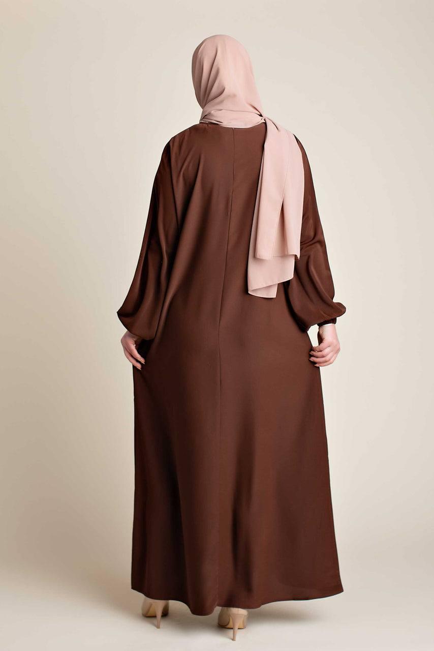 Model wearing a classic Abaya with side pockets in a chocolate brown color - Rear pose - Momina Hijabs