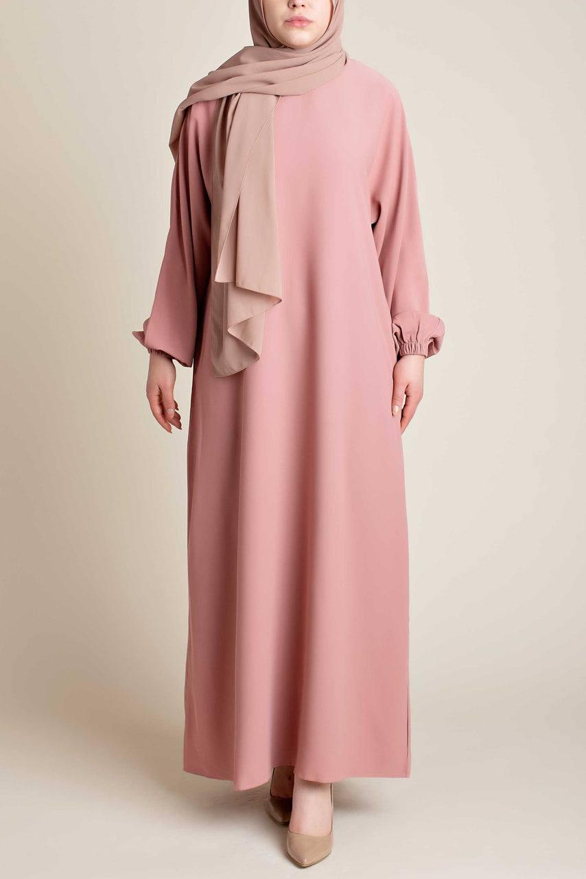 Model wearing a classic Abaya with side pockets in a pink color - Front pose - Momina Hijabs