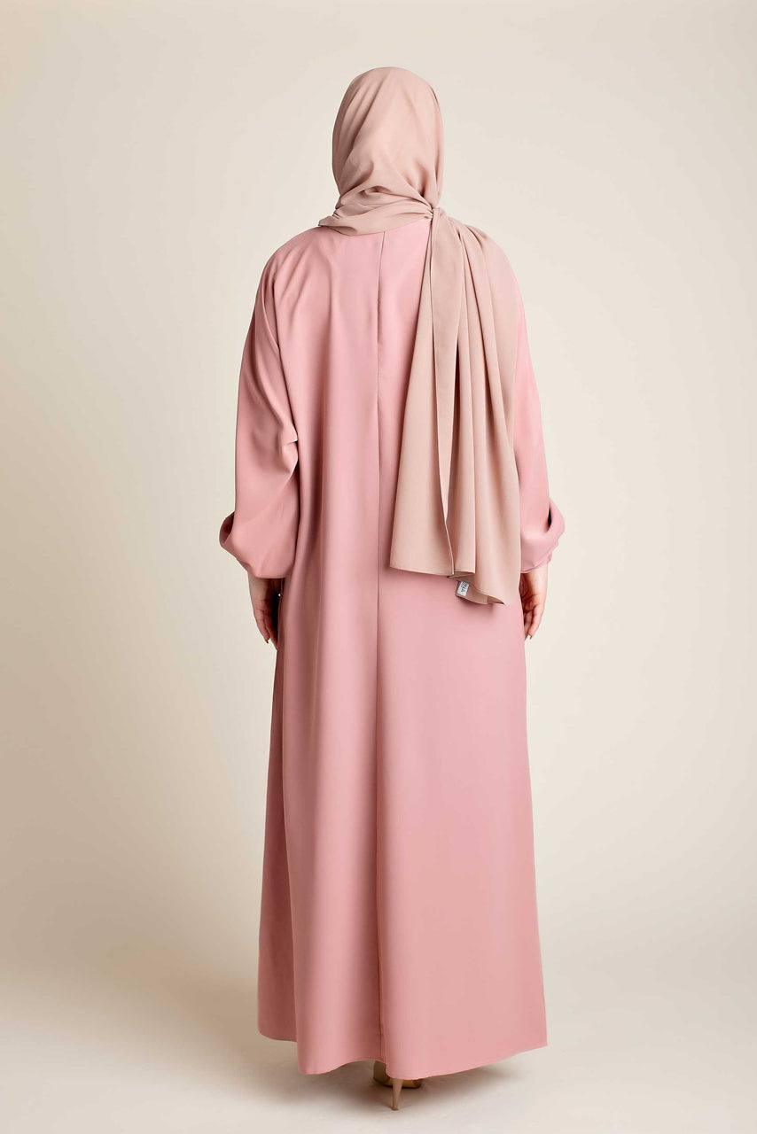 Model wearing a classic Abaya with side pockets in a pink color - Rear pose - Momina Hijabs