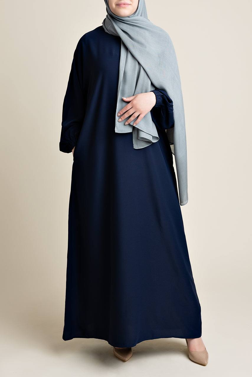 Model wearing a classic Abaya with side pockets in a navy blue color - Front pose - Momina Hijabs