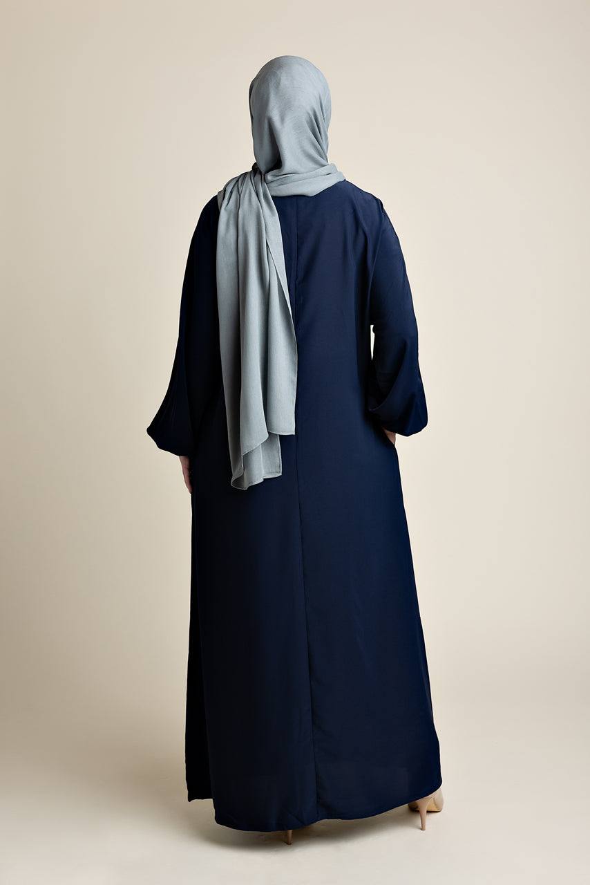Model wearing a classic Abaya with side pockets in a navy blue color - Rear pose - Momina Hijabs