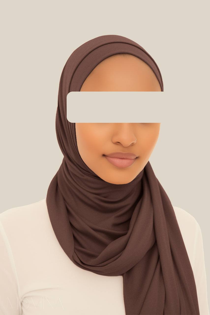 A woman wearing a dark brown matching jersey hijab set by Momina Hijabs.