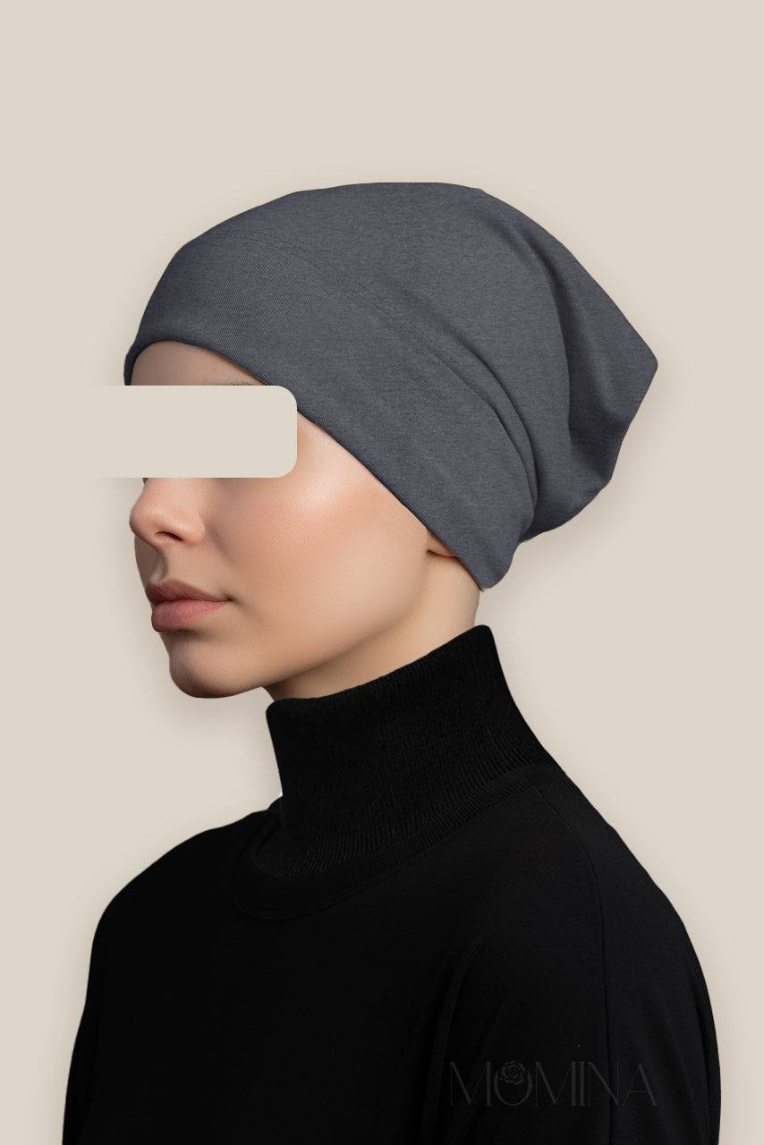 Woman wearing a dark gray marble jersey hijab under cap by Momina Hijabs