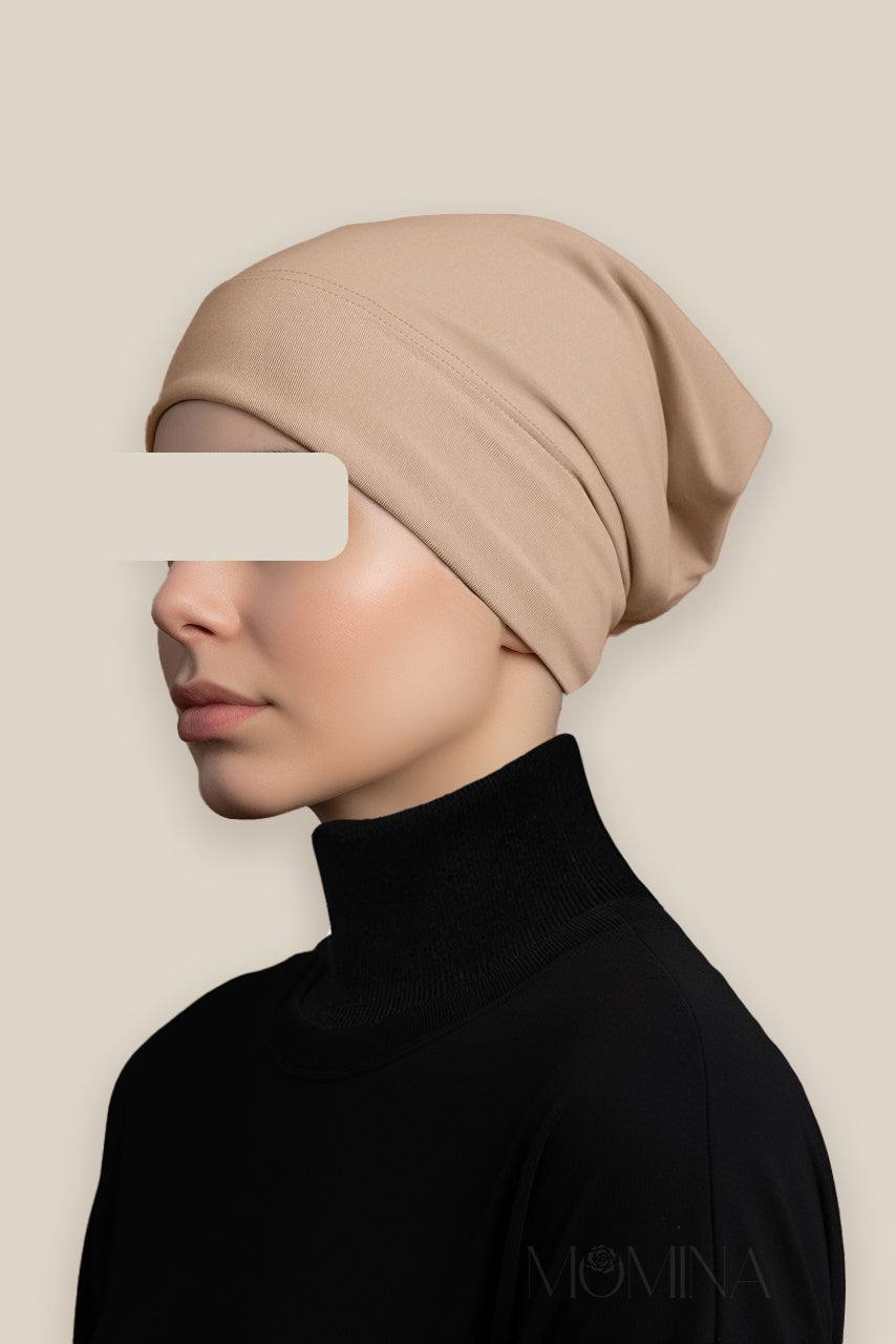 A woman wearing a beige tube undercap by Momina Hijabs