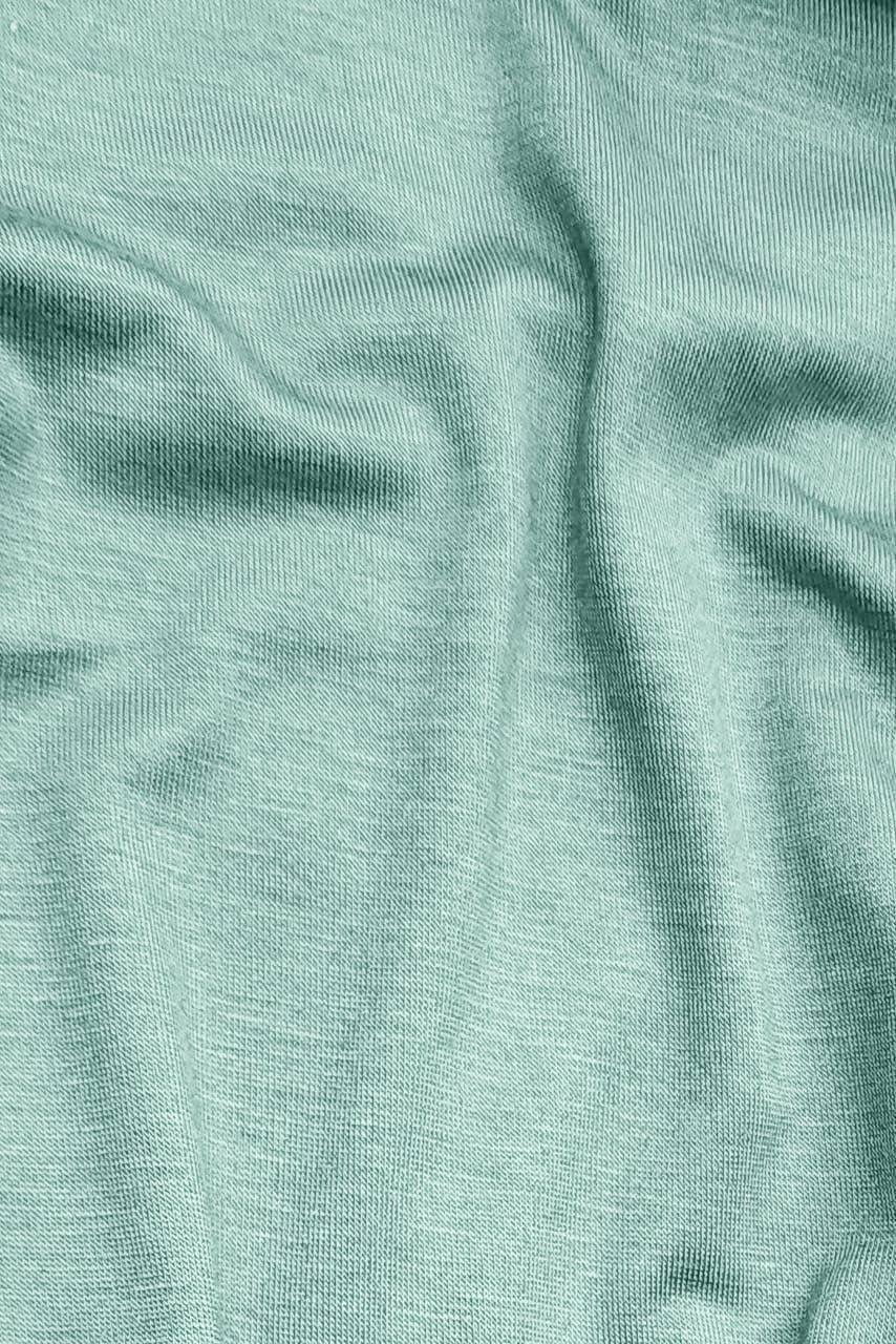 Close up fabric image of a pale mint jersey hijab by Momina Hijabs