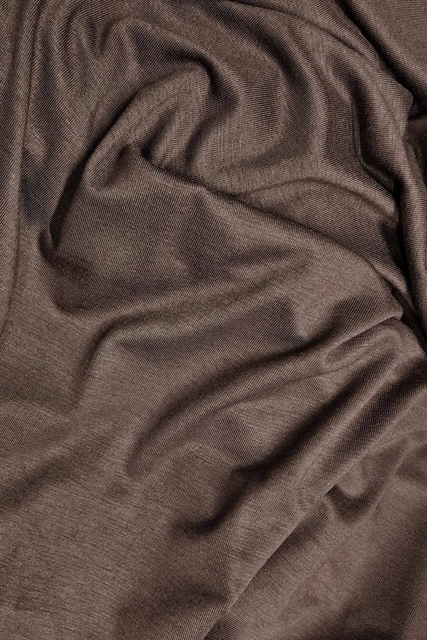 Fabric close up image of a muted dark brown jersey hijab by Momina Hijabs