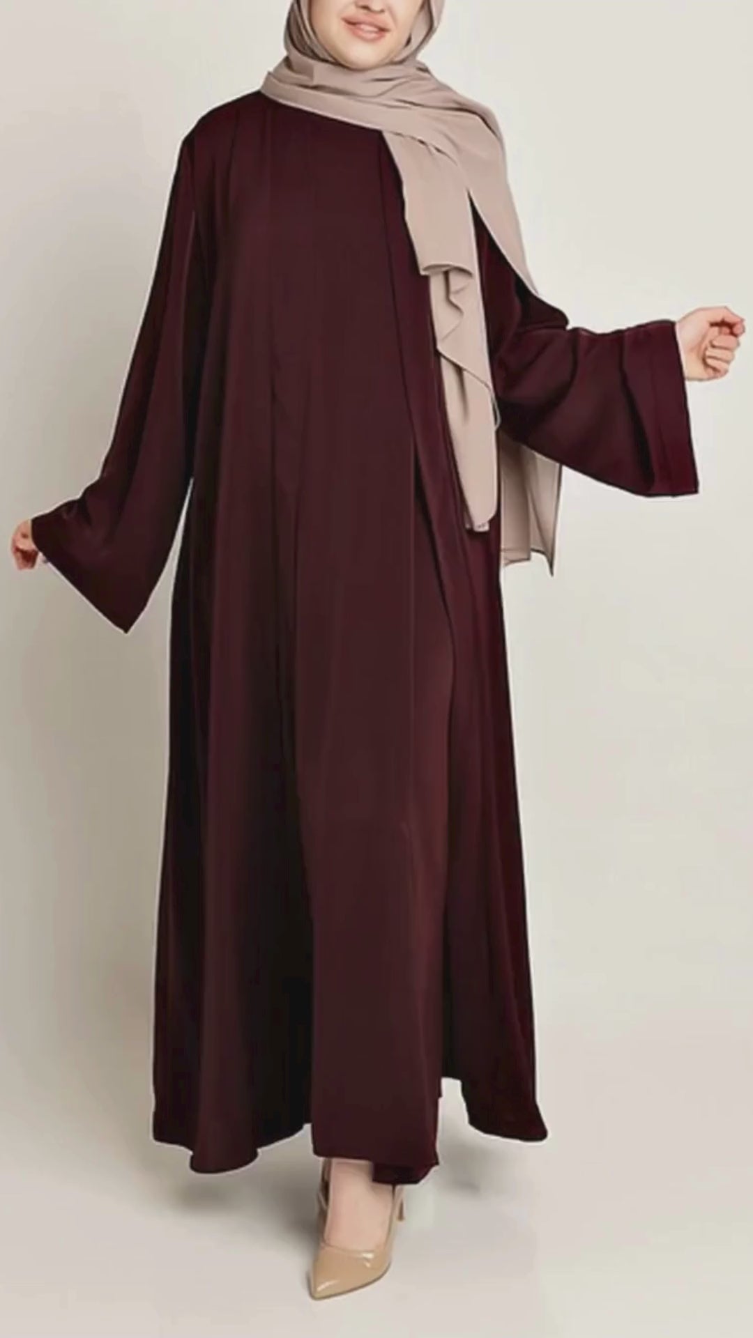A woman wearing the Beetroot Abaya Set by Momina Hijabs