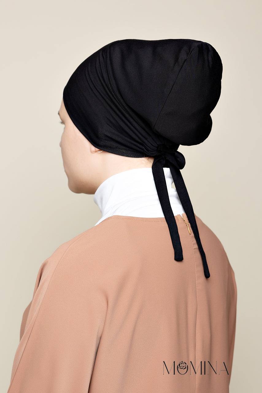 Model wearing a Black colored Satin Lined Undercap in a tie-back design made with Bamboo jersey - Rear view showcasing the tie-back bands - Momina Hijabs